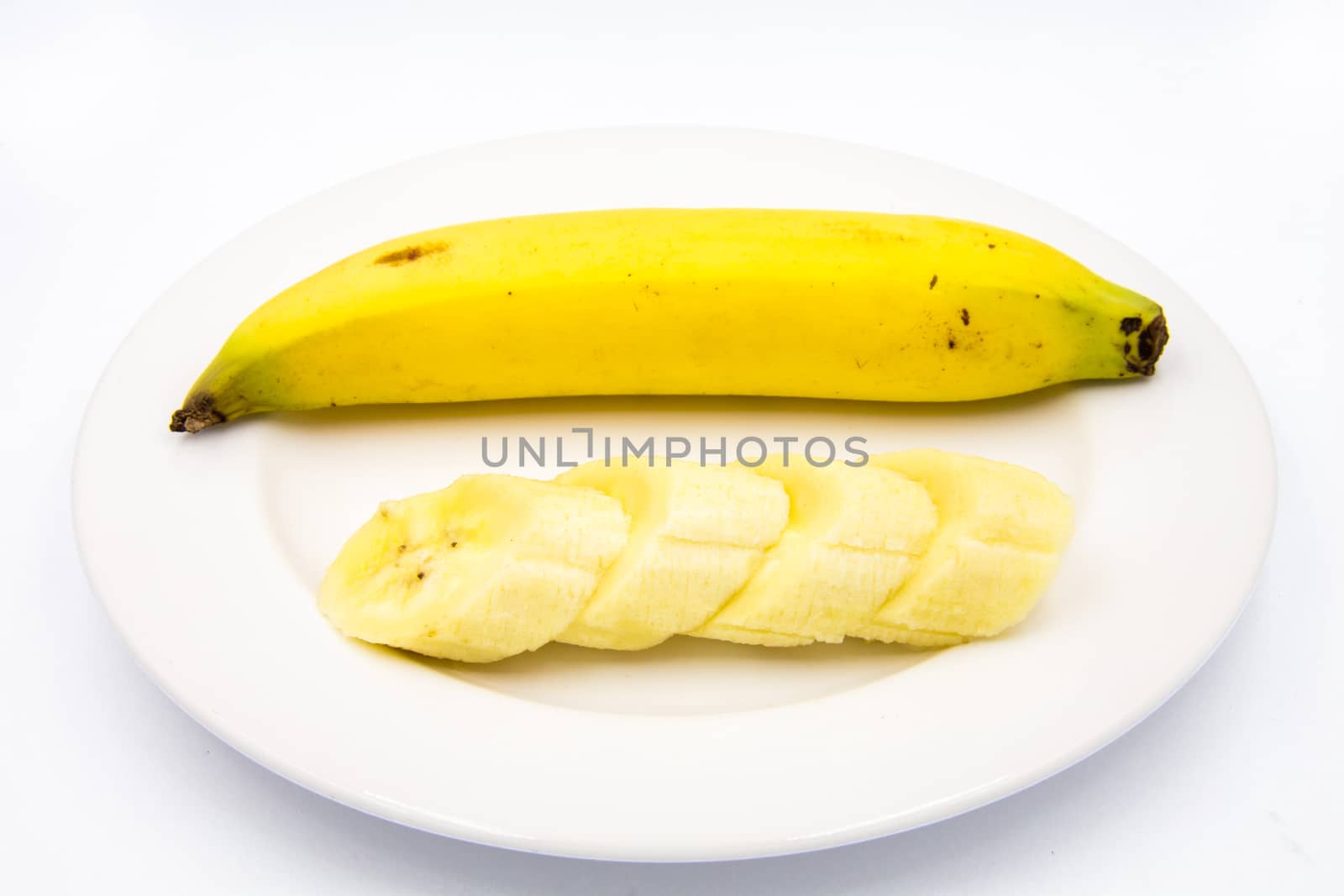 The banana slices were placed on a white plate.