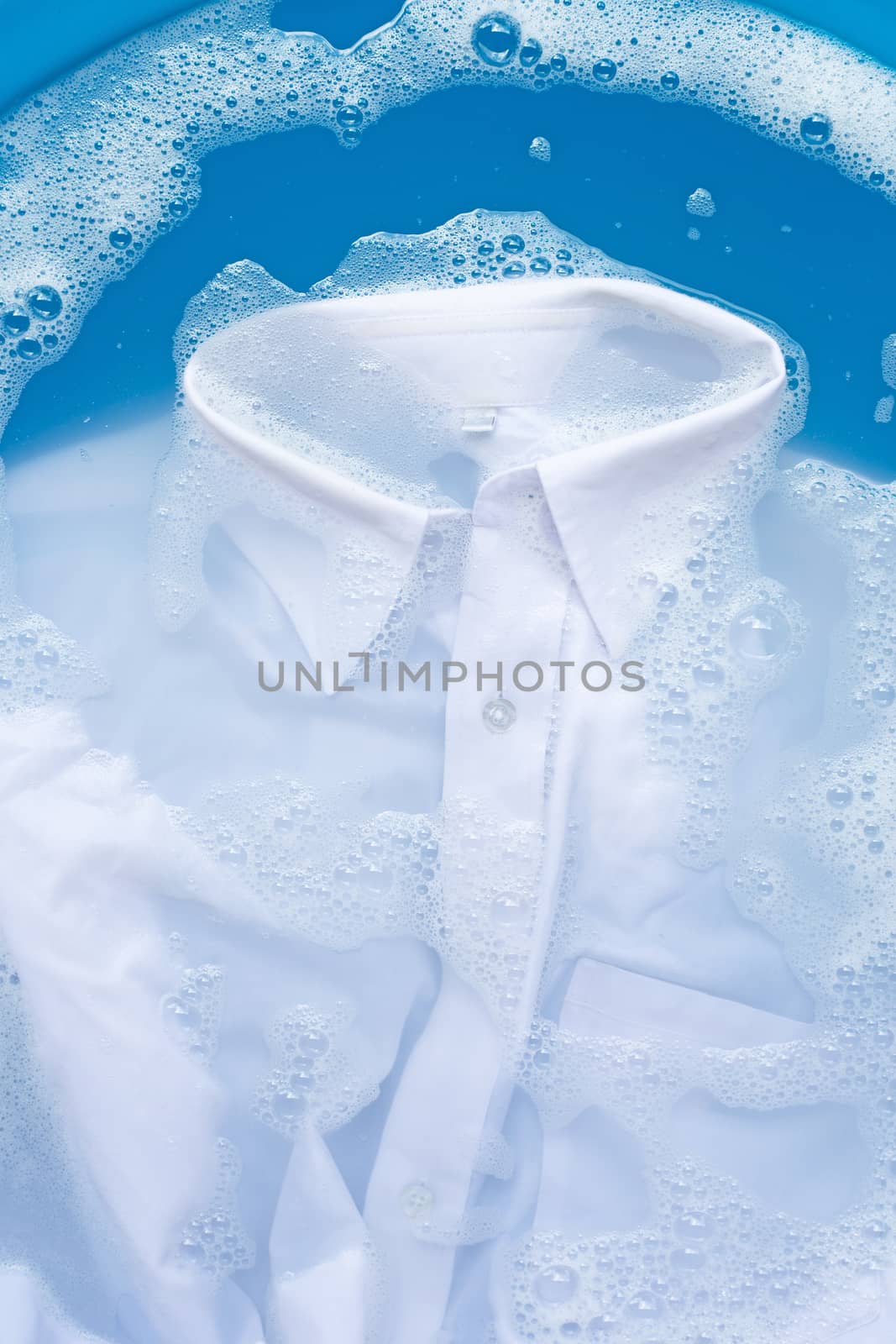 White shirt soak in powder detergent water dissolution, washing  cloth. Laundry concept