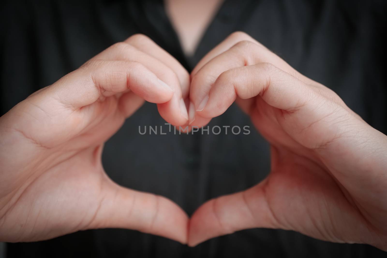 Woman hand do heart shape metaphor love and care background.