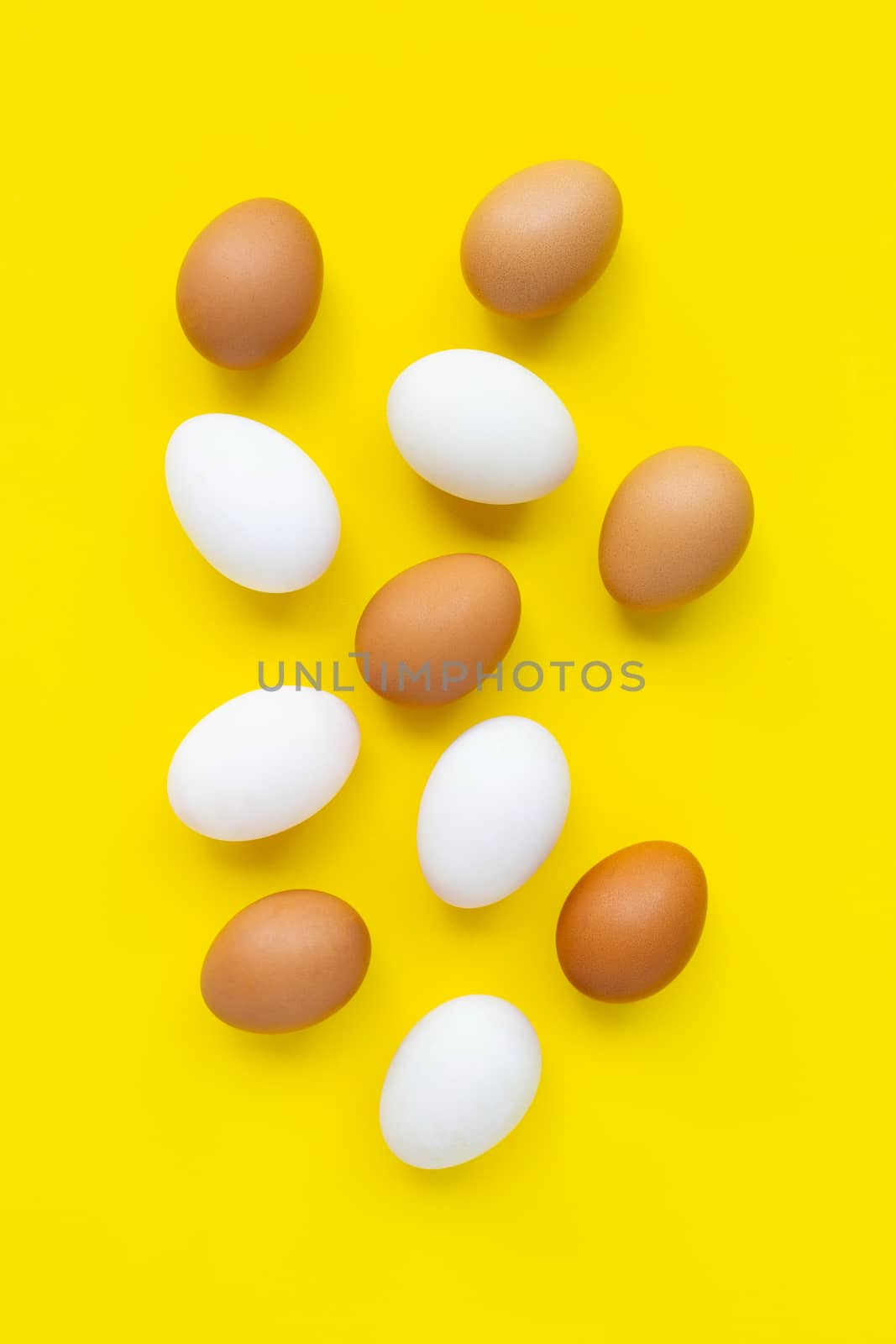Eggs on yellow background.  by Bowonpat