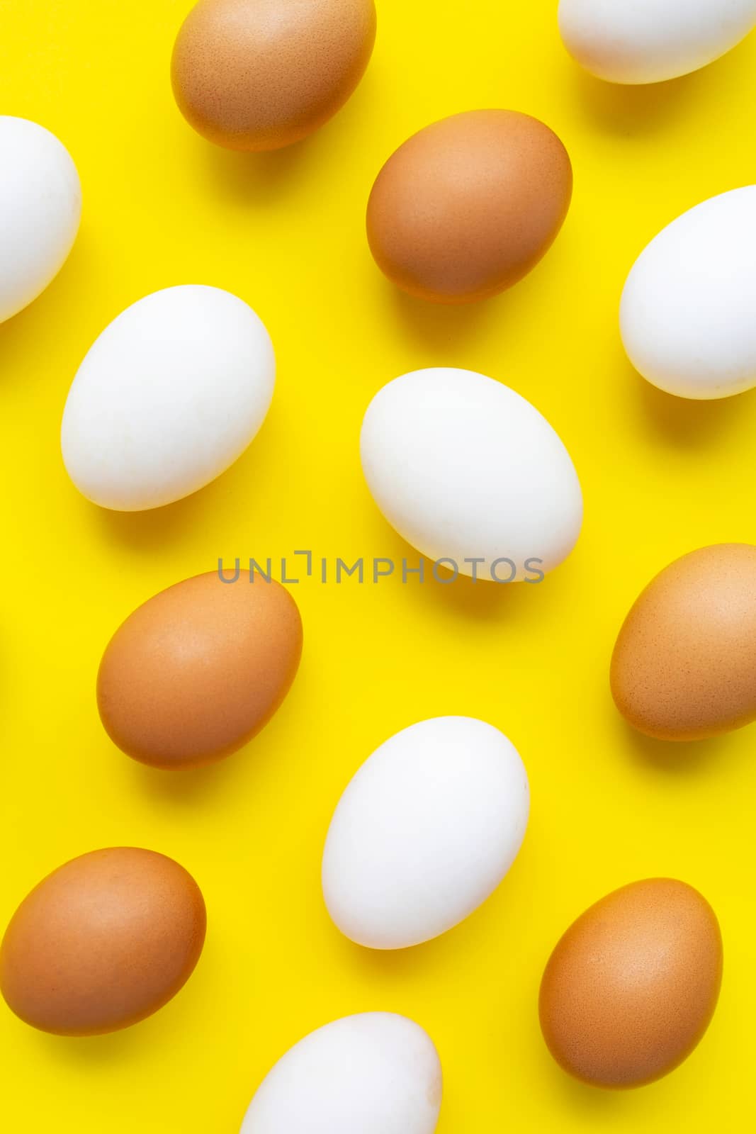 Eggs on yellow background.  by Bowonpat