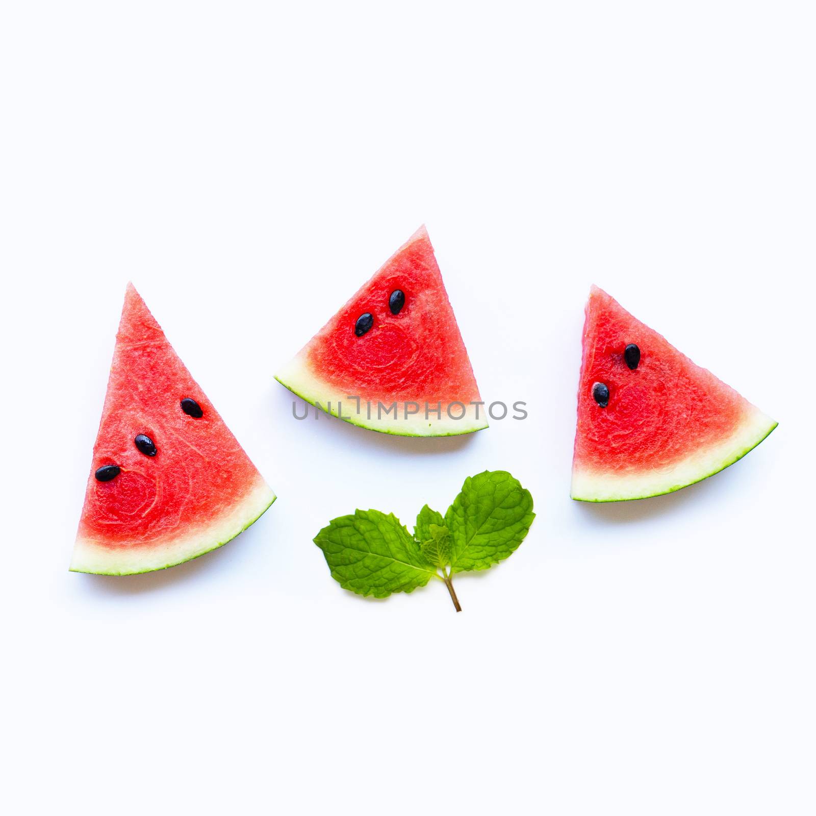 Fresh watermelon slices with mint leaves on white background. Copy space