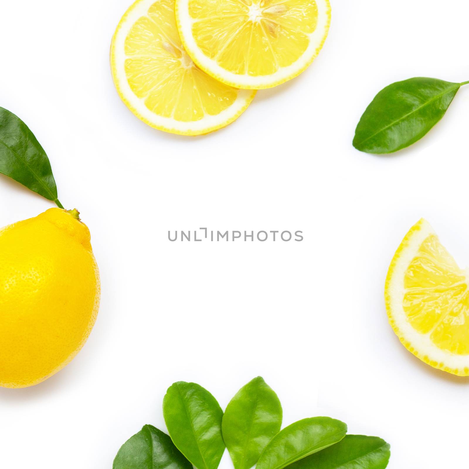 Frame made of fresh lemon and slices with leaves isolated on white background.