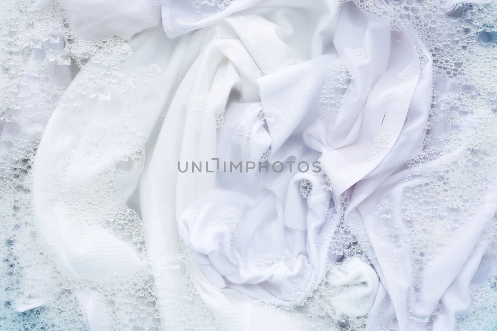 White shirt soak in powder detergent water dissolution. Laundry  by Bowonpat