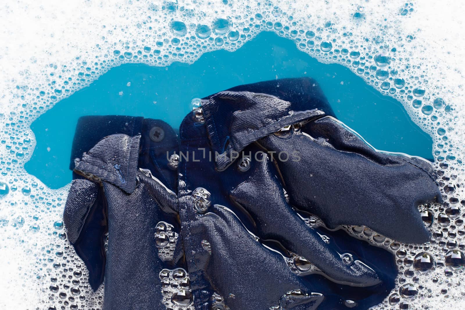Shirt soak in powder detergent water dissolution, washing cloth. Laundry concept