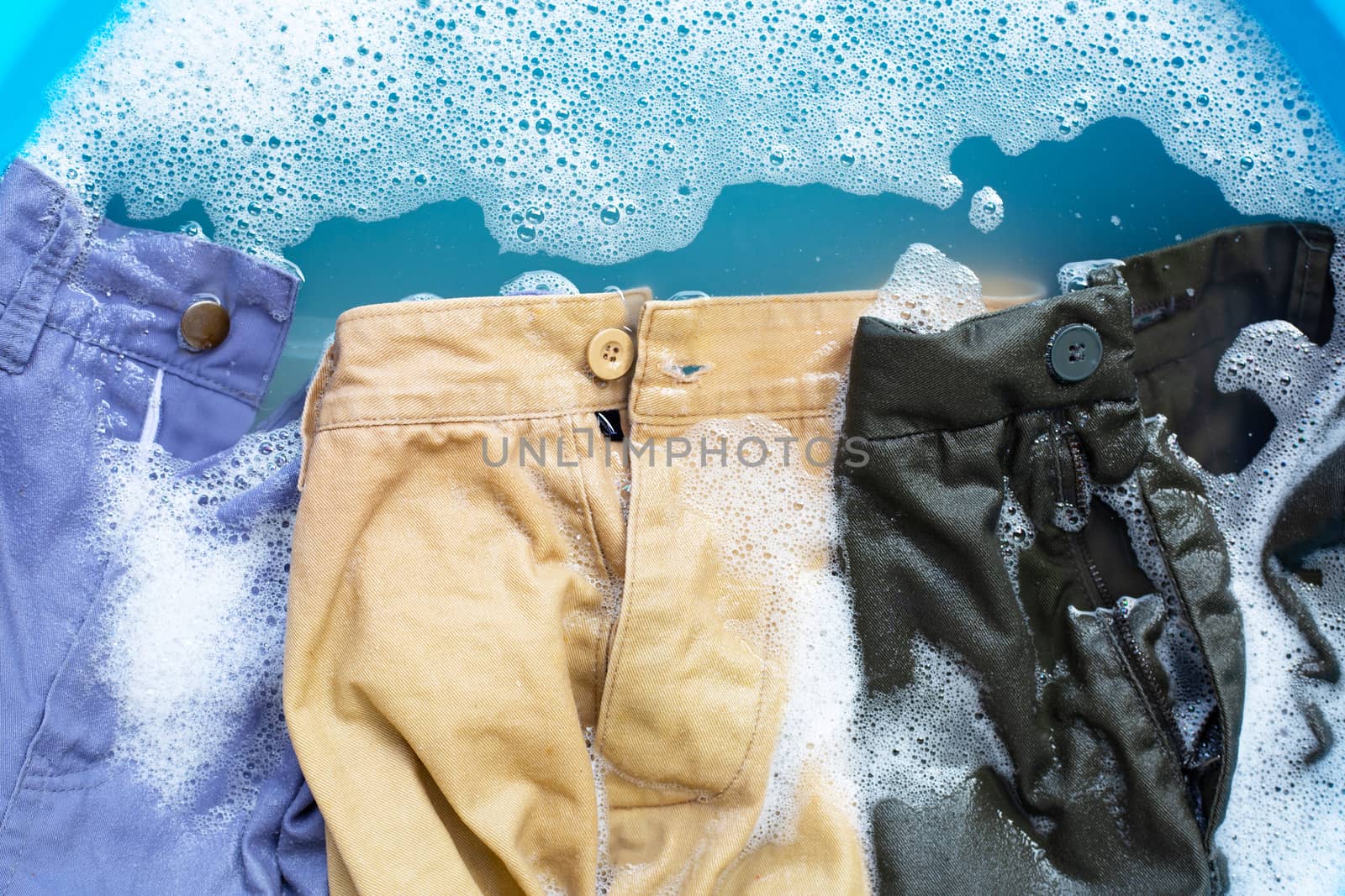 Trousers soak in powder detergent water dissolution. Laundry con by Bowonpat