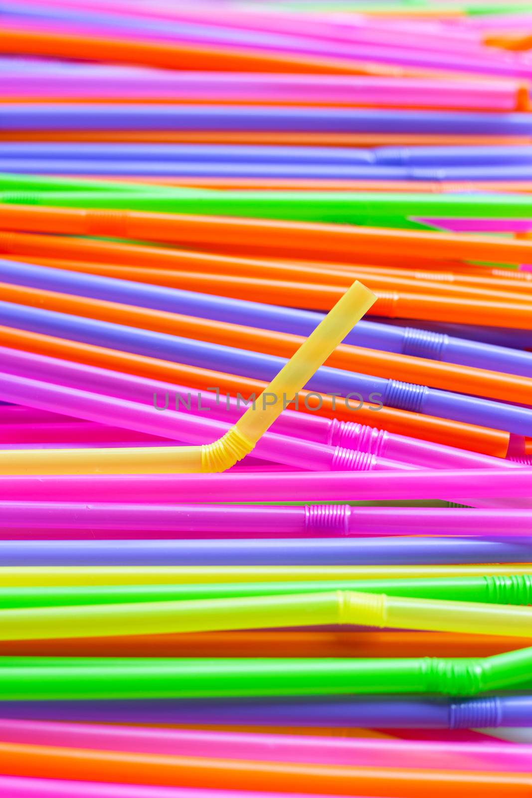 Colorful plastic straws background. Plastic waste pollution.