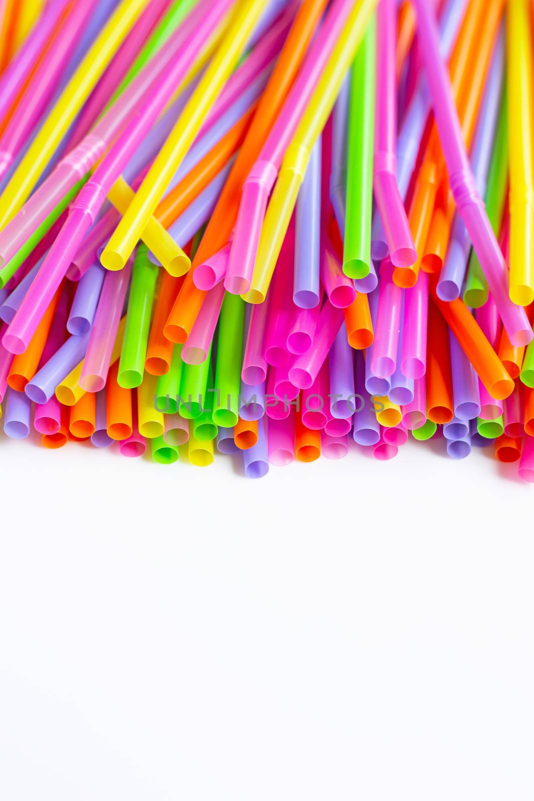 Colorful plastic  straws on white background. by Bowonpat