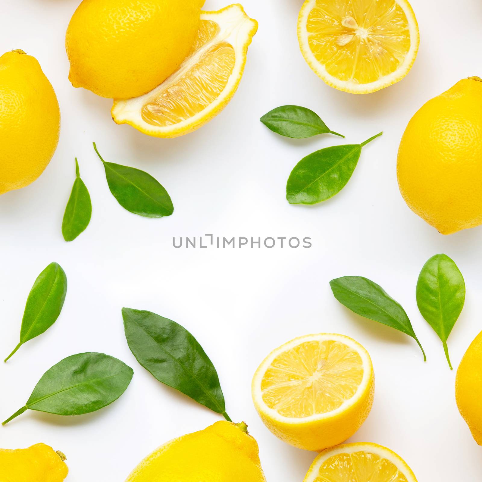 Frame made of fresh lemon and  slices with leaves isolated on white background.