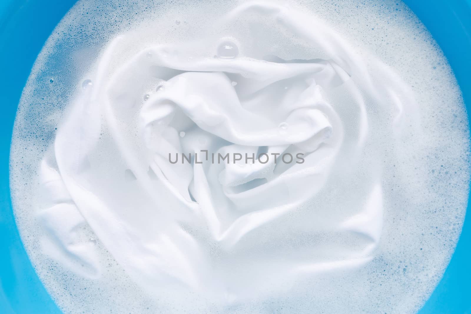 Soak a cloth before washing, white cloth.  by Bowonpat