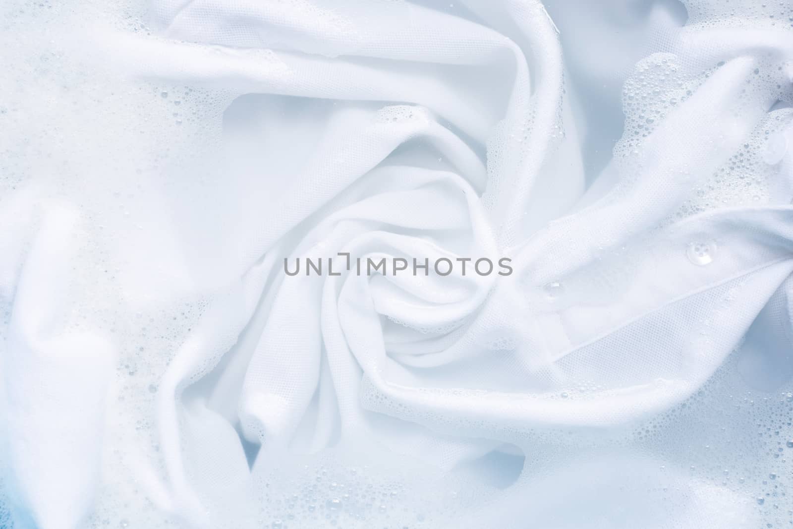 Soak a cloth before washing, white cloth.  by Bowonpat