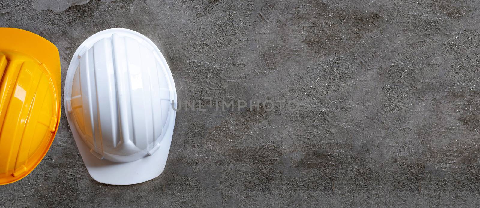 Construction helmets on concrete background. Copy space