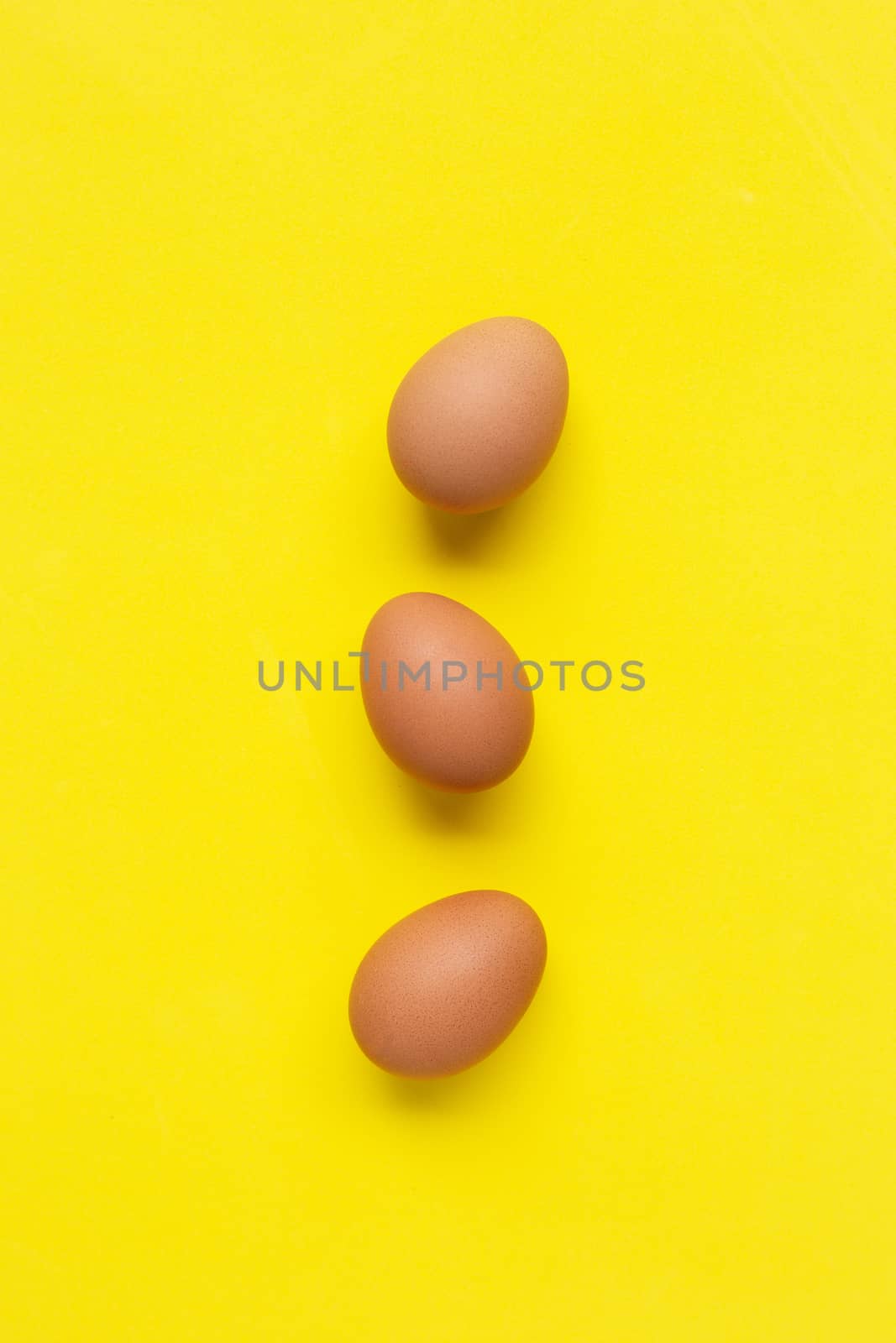Eggs on yellow background. by Bowonpat