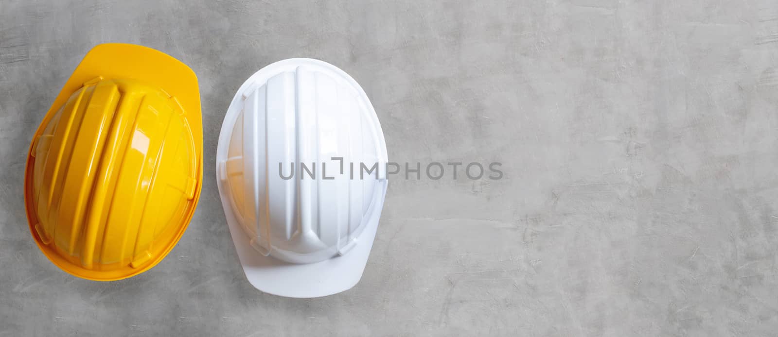 Construction helmets on concrete background. Copy space