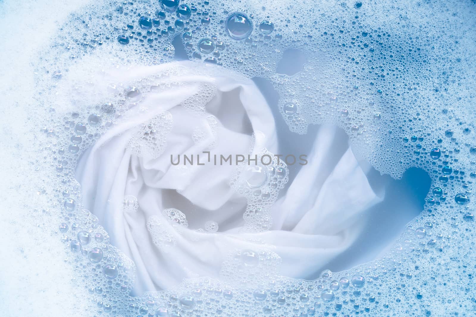 Soak a cloth before washing, white cloth by Bowonpat
