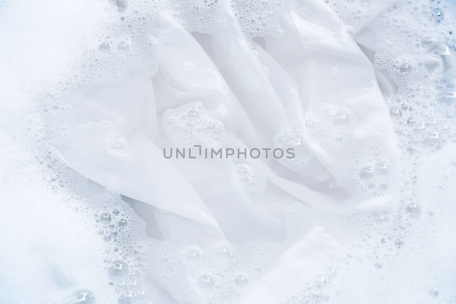 Soak a cloth before washing, white cloth by Bowonpat