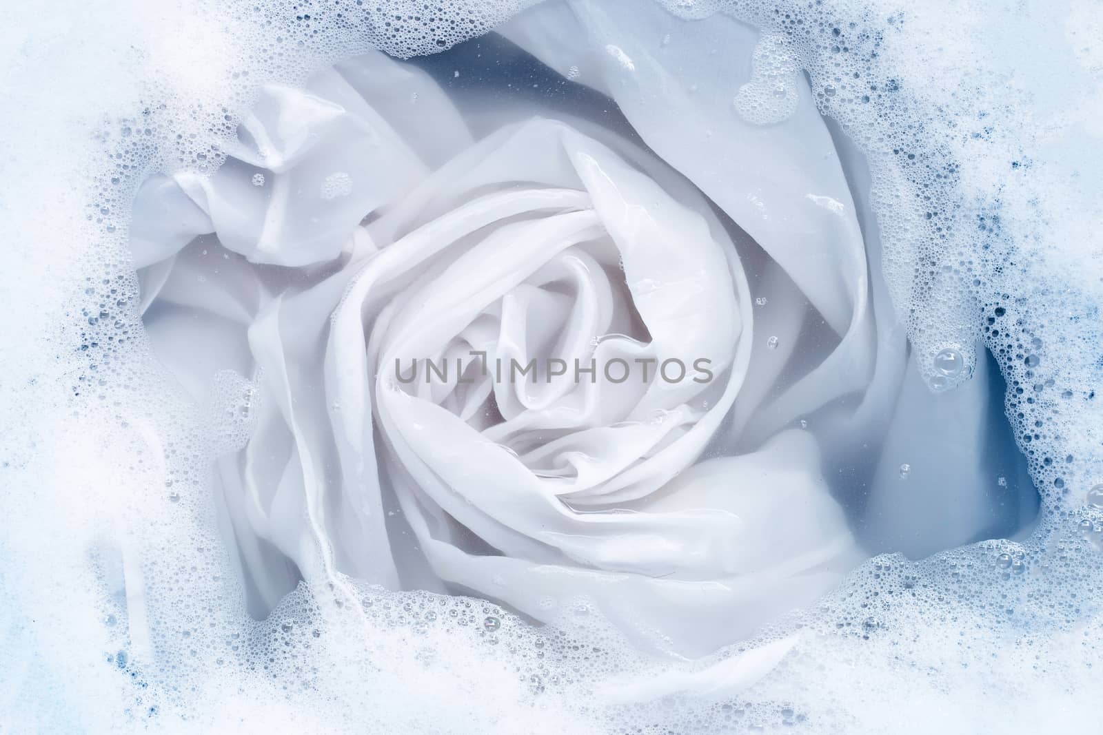 Soak a cloth before washing, white cloth by Bowonpat