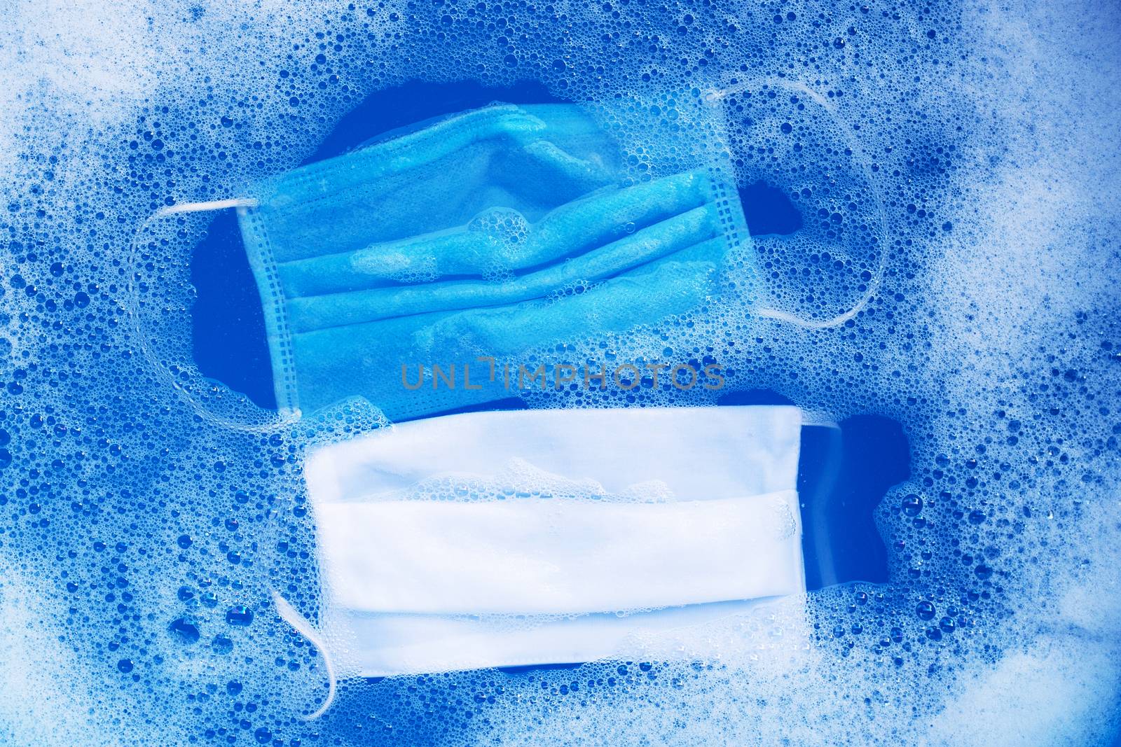 Protective medical mask with cloth mask soak in powder detergent water dissolution before washing.