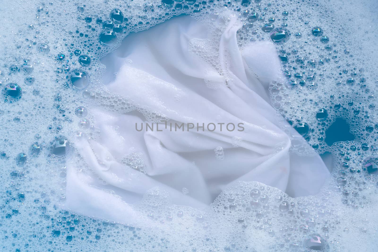 Soak a cloth before washing, white cloth by Bowonpat