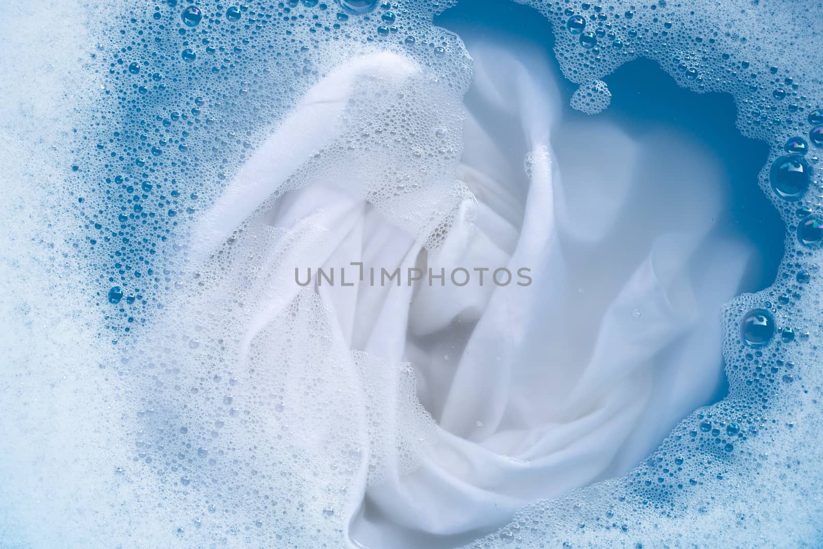 Soak a cloth before washing, white cloth by Bowonpat