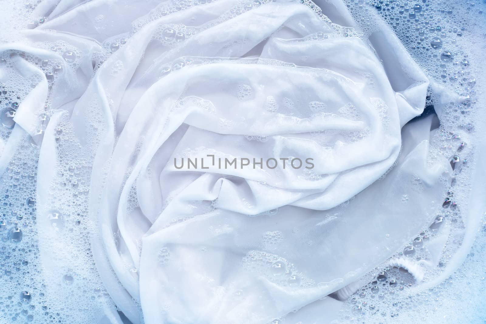 Soak a cloth before washing, white cloth by Bowonpat