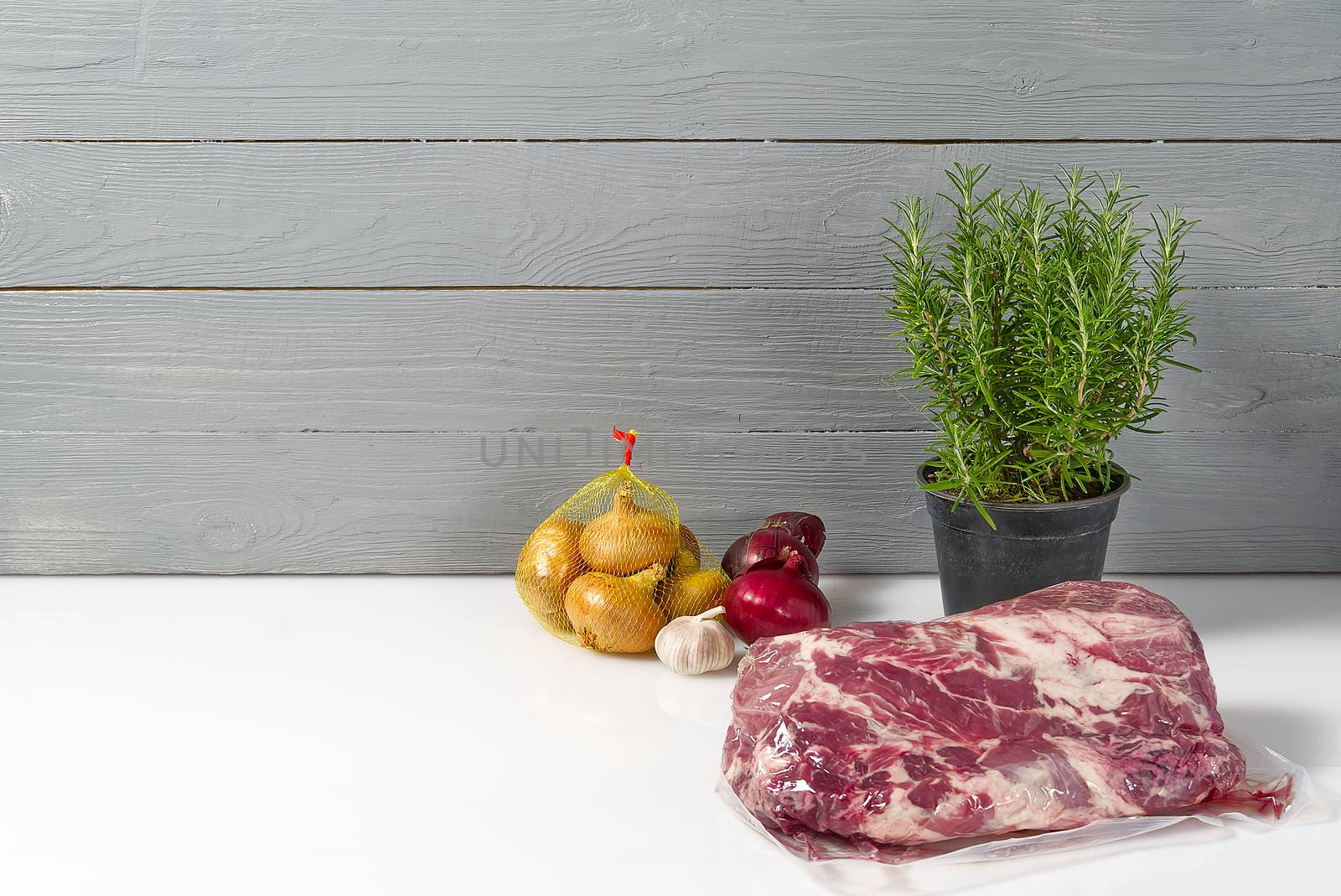 Raw pork neck on white table with vegetables