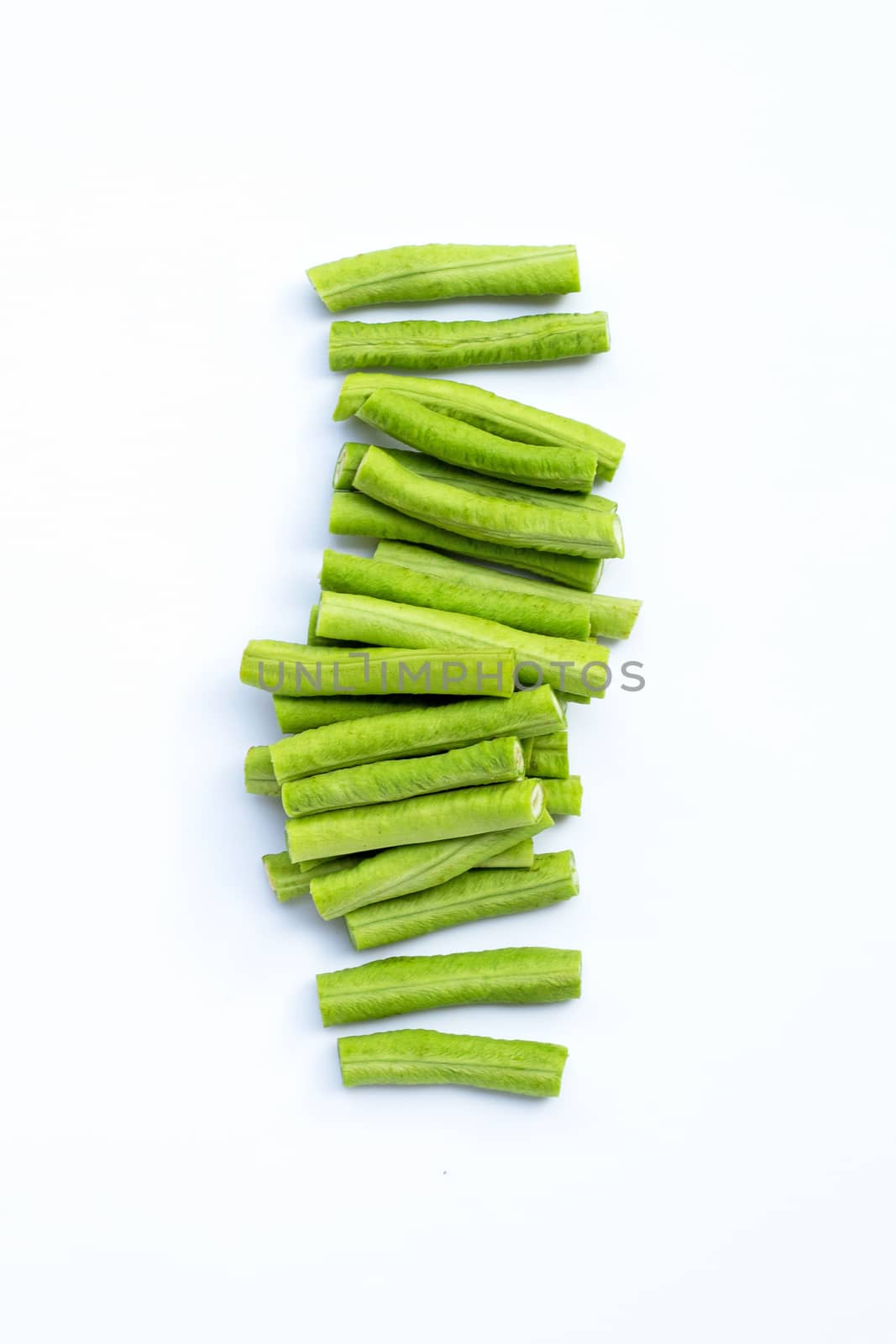 Cut long bean or cowpea on white background. Copy space by Bowonpat