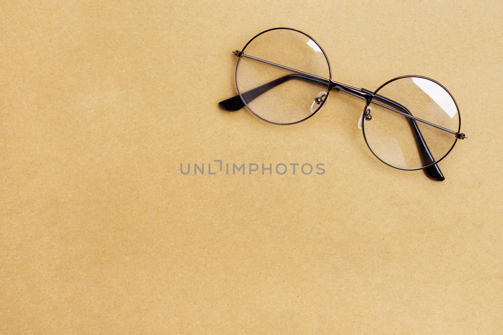 Eye Glasses on brown paper background. Copy space