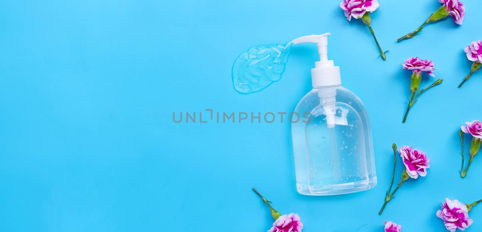 Alcohol hand sanitizer gel in pump bottle with carnation flower  by Bowonpat