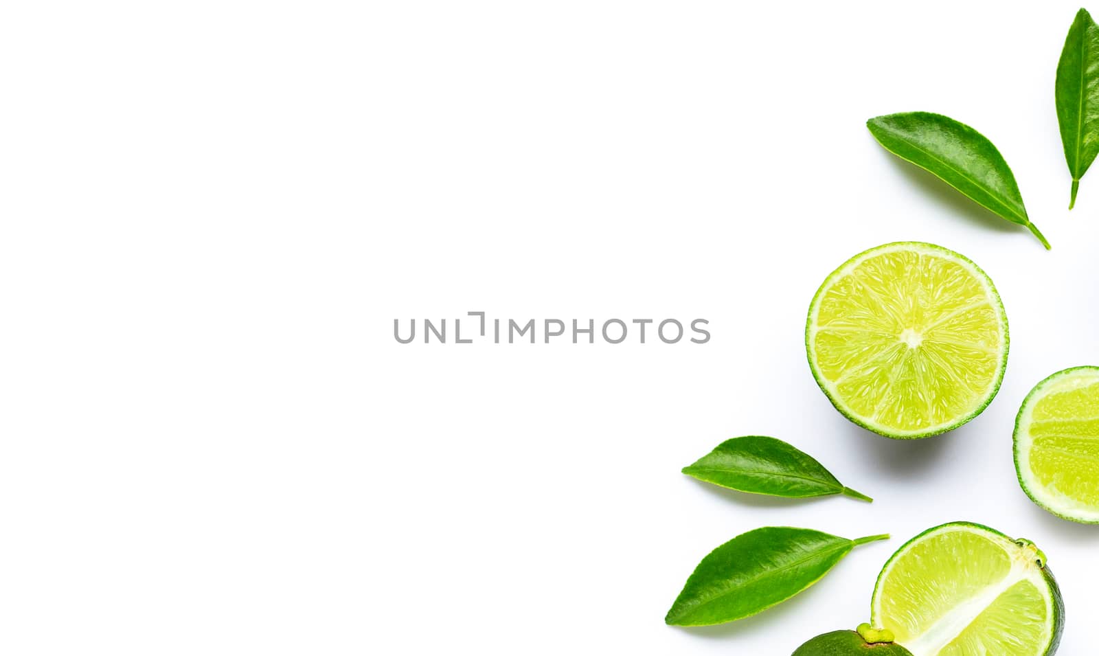 Limes with leaves isolated on white background.