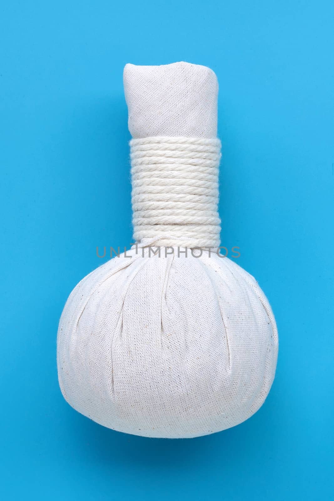 Herbal compress ball for Thai massage and spa treatment  on blue background. 