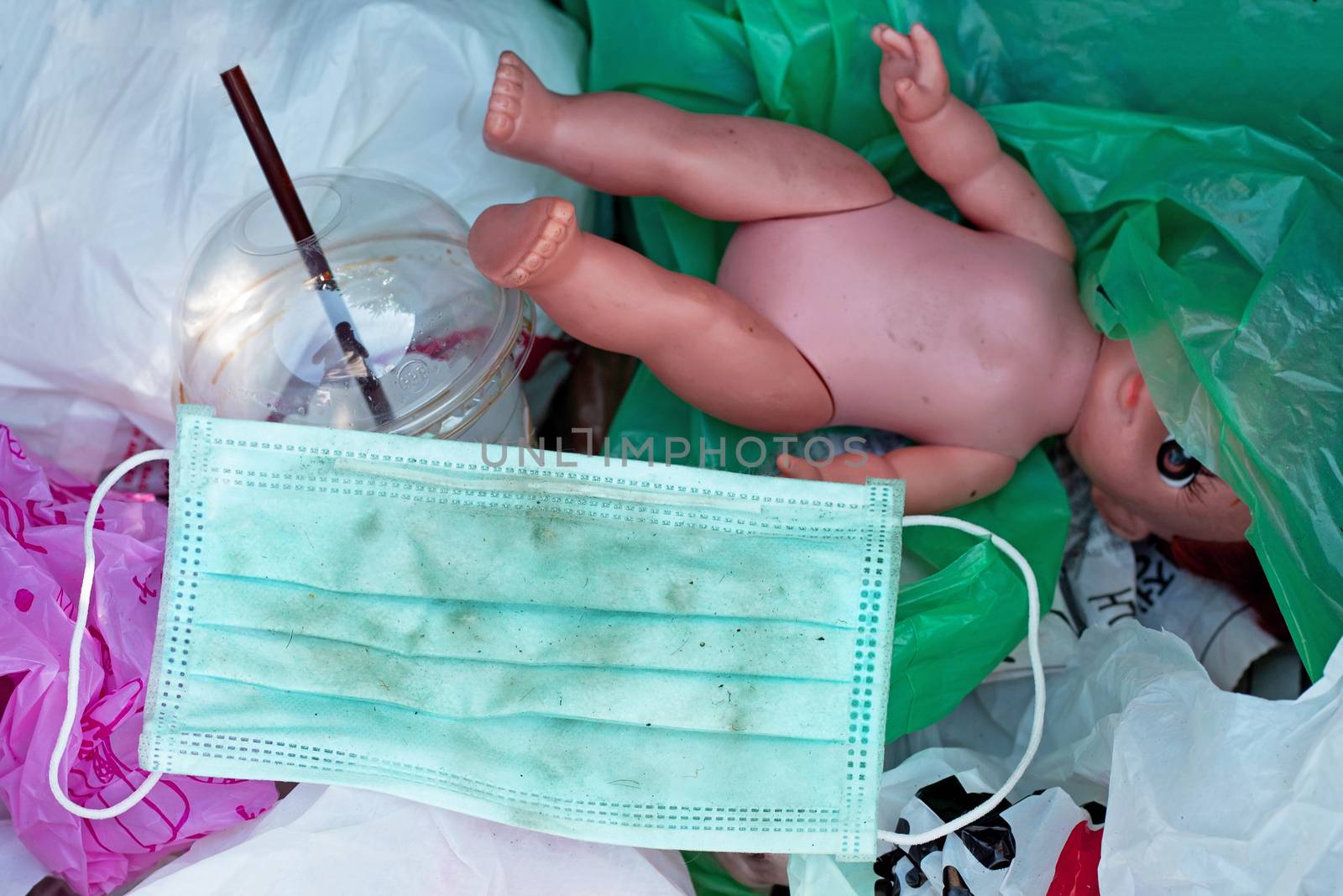 Dirty used surgical mask in a garbage bin.
