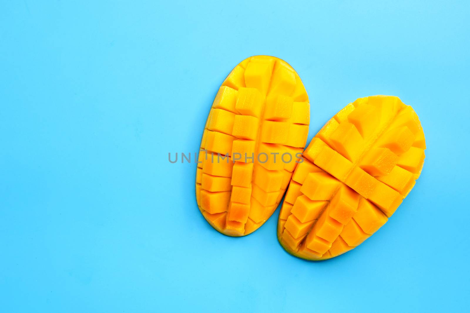 Tropical fruit, Mango  on blue background. Copy space