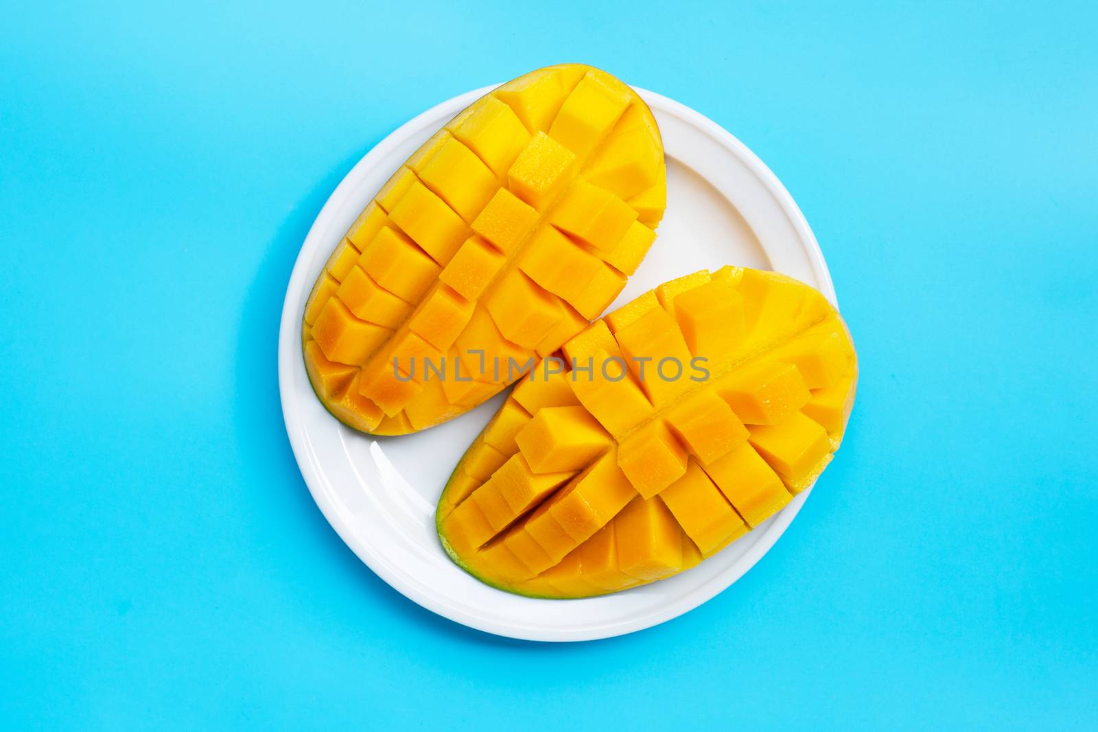 Tropical fruit, Mango on blue background. Top view