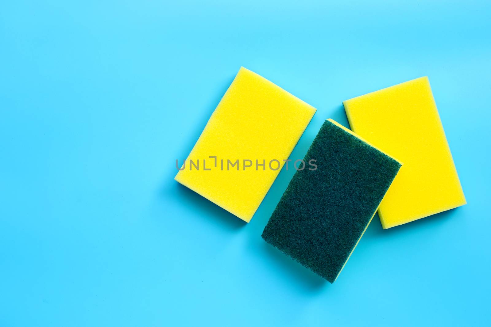Scrub sponges on blue background. Copy space, Top view