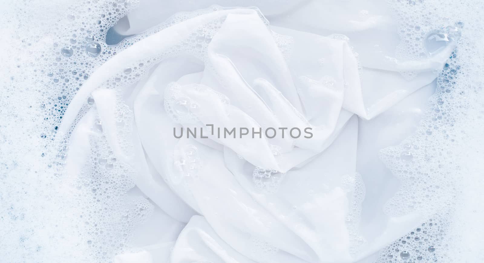Top view of soak a cloth before washing, white cloth
