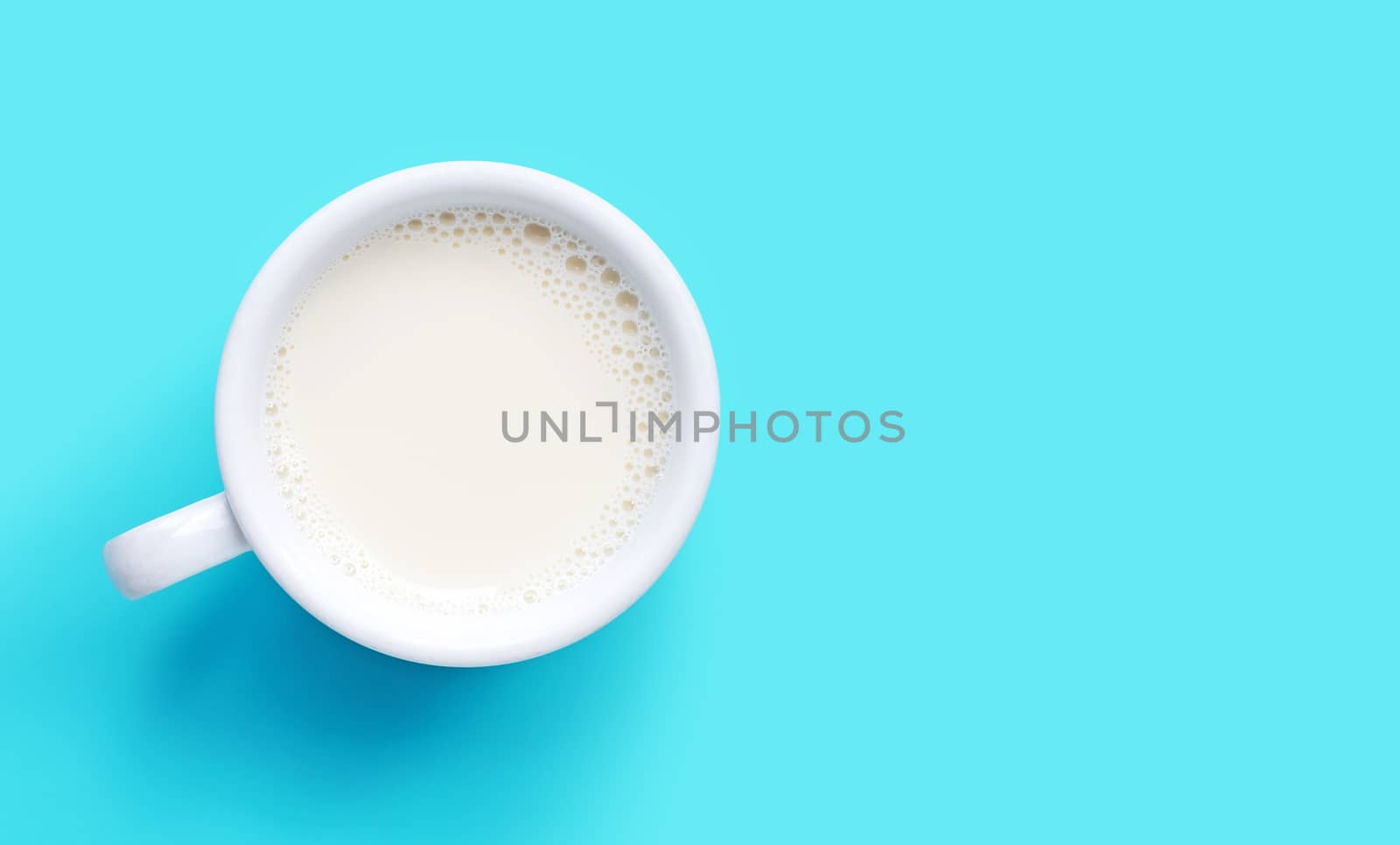Cup of milk on blue background. Copy space