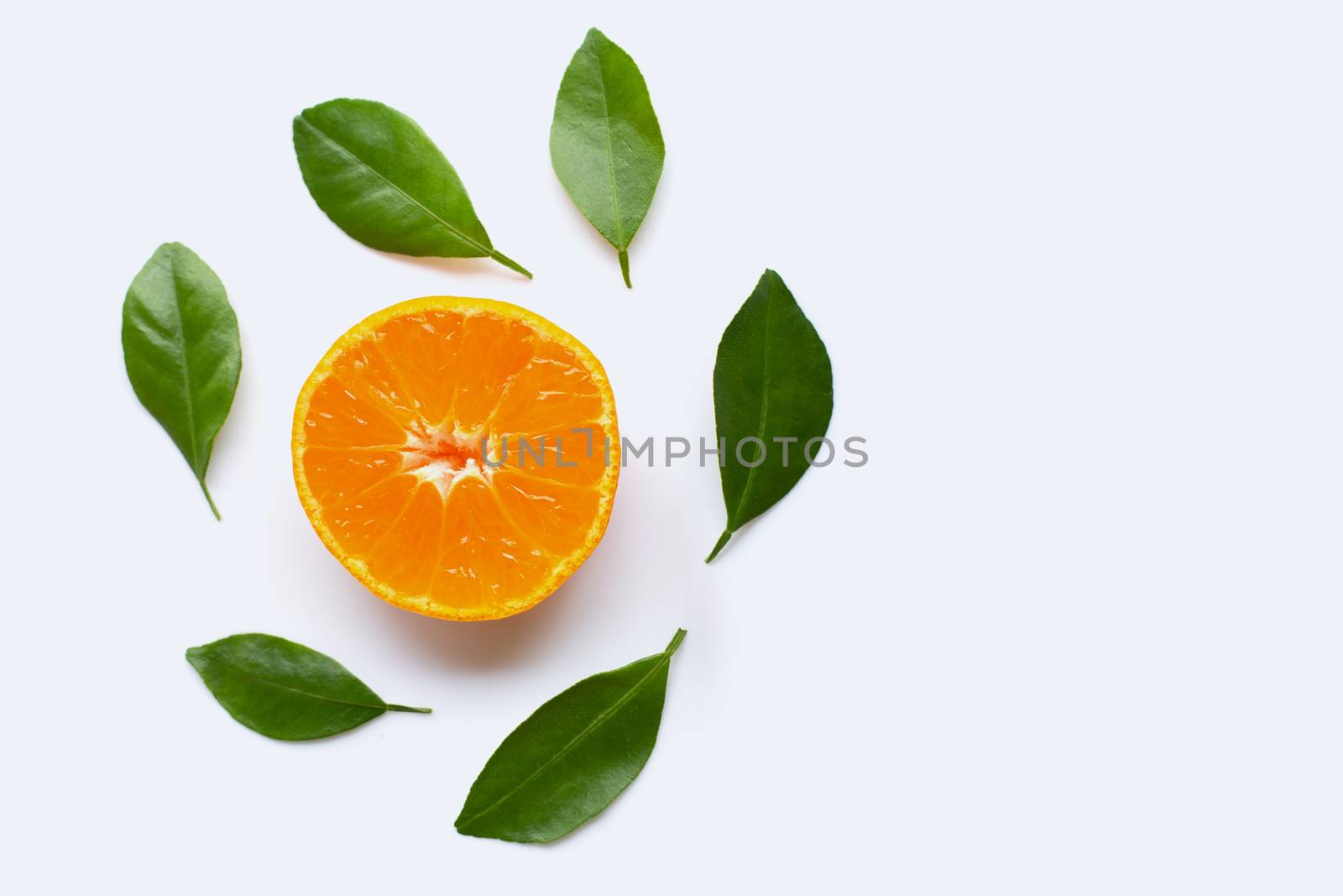 Fresh orange citrus fruit with green leaves on white background.