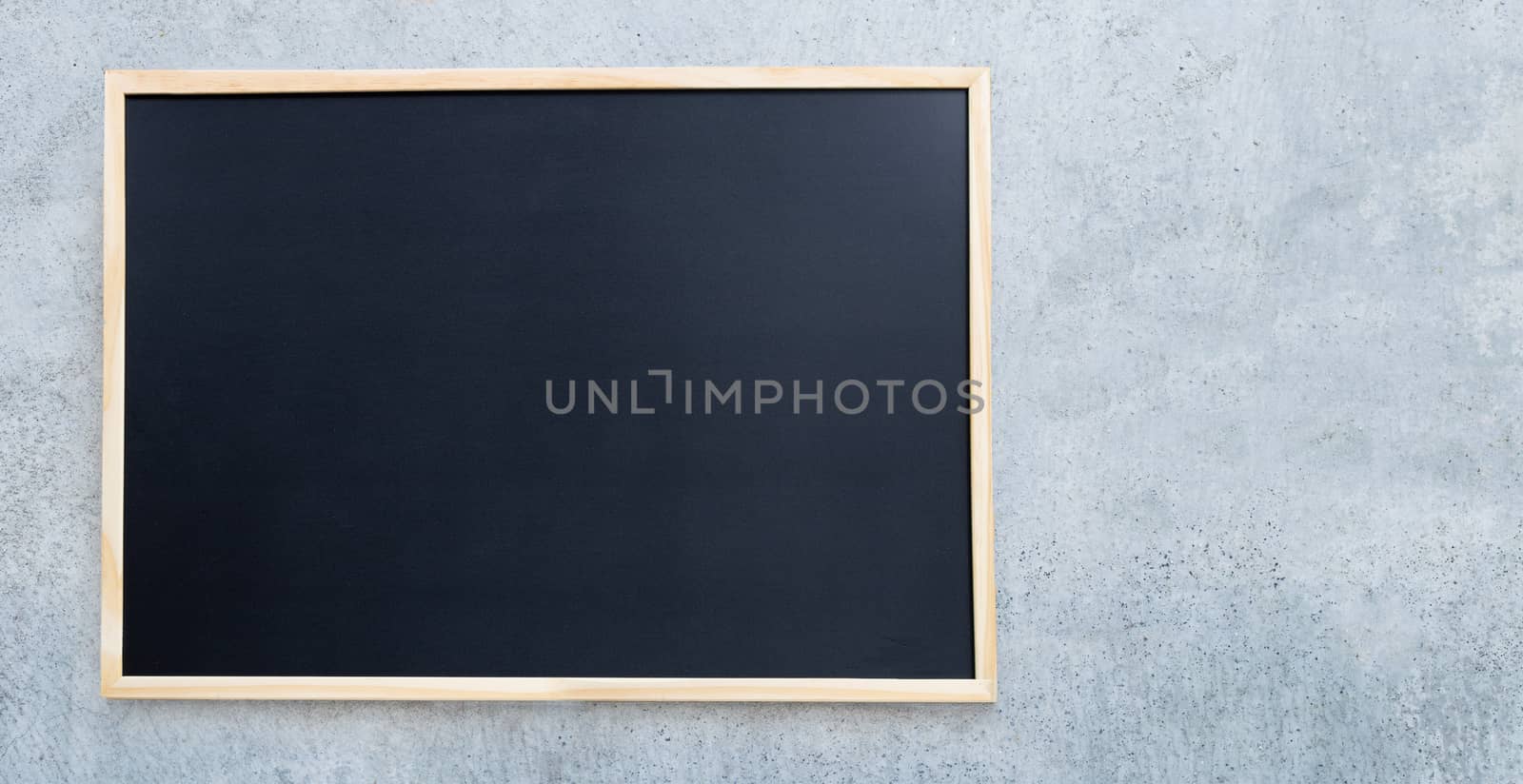 Black school chalkboard on concrete wall for background.  Copy space
