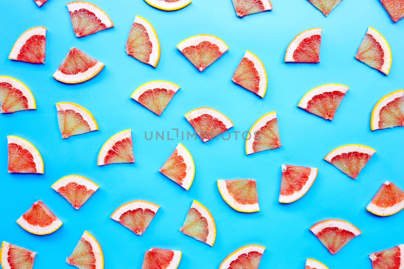 High vitamin C. Juicy grapefruit slices on blue background. Top view