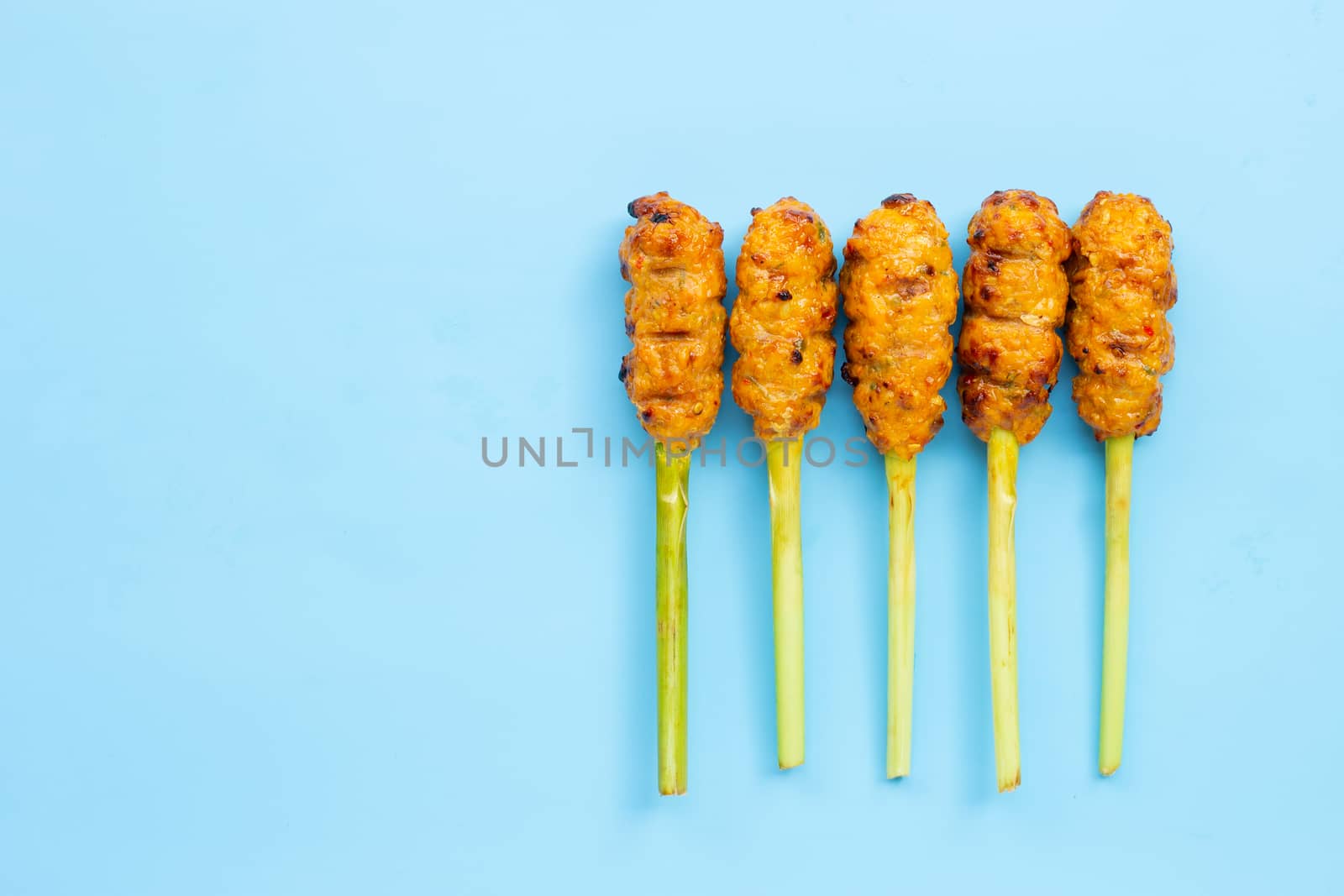 Grilled minced chicken with curry paste and coconut cream on lemongrass skewers. Copy space