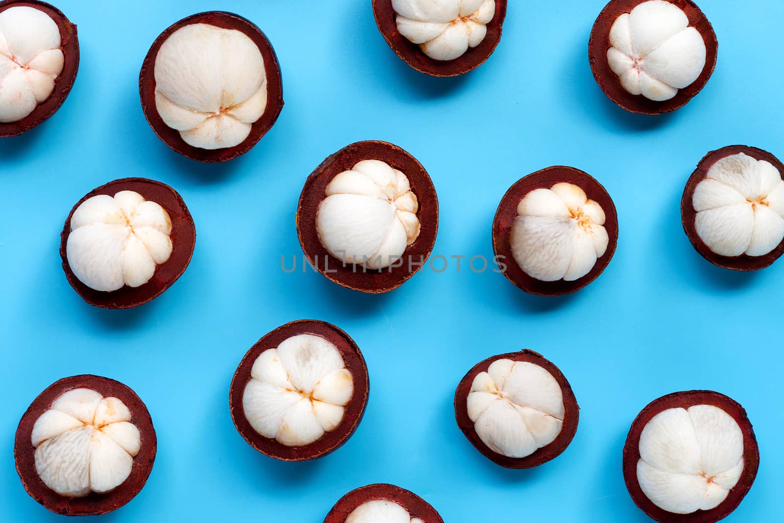 Mangosteen on blue background. Top view