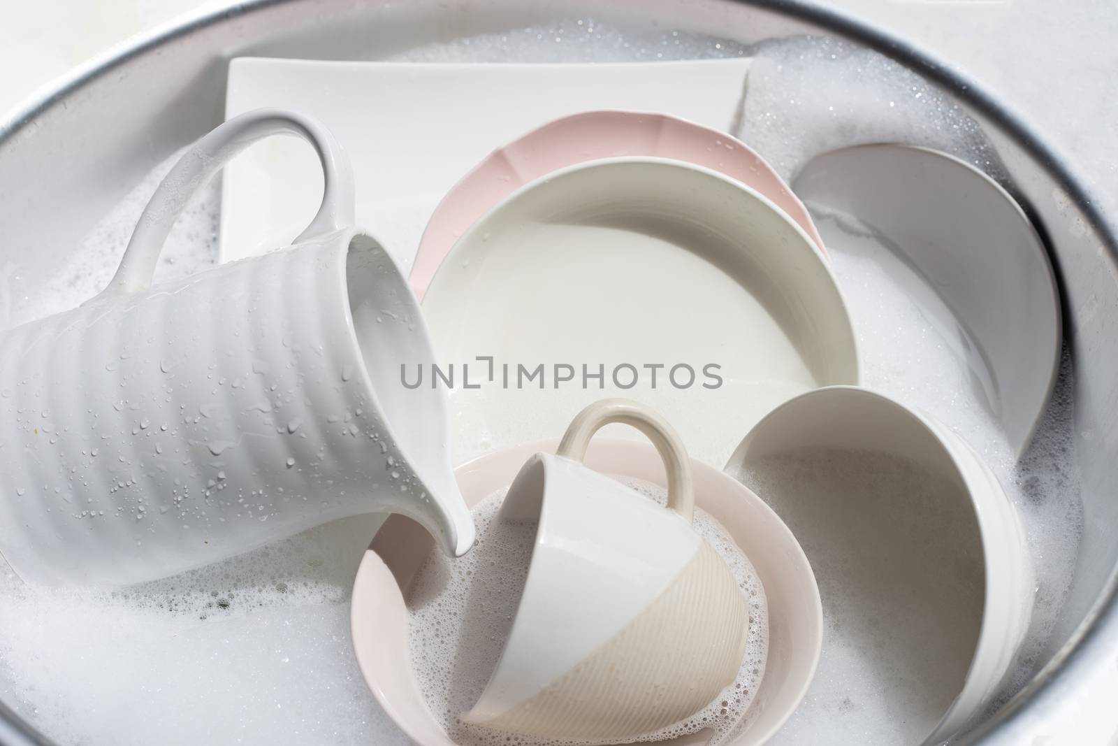Dish washing, Close up of utensils soaking in kitchen sink. 