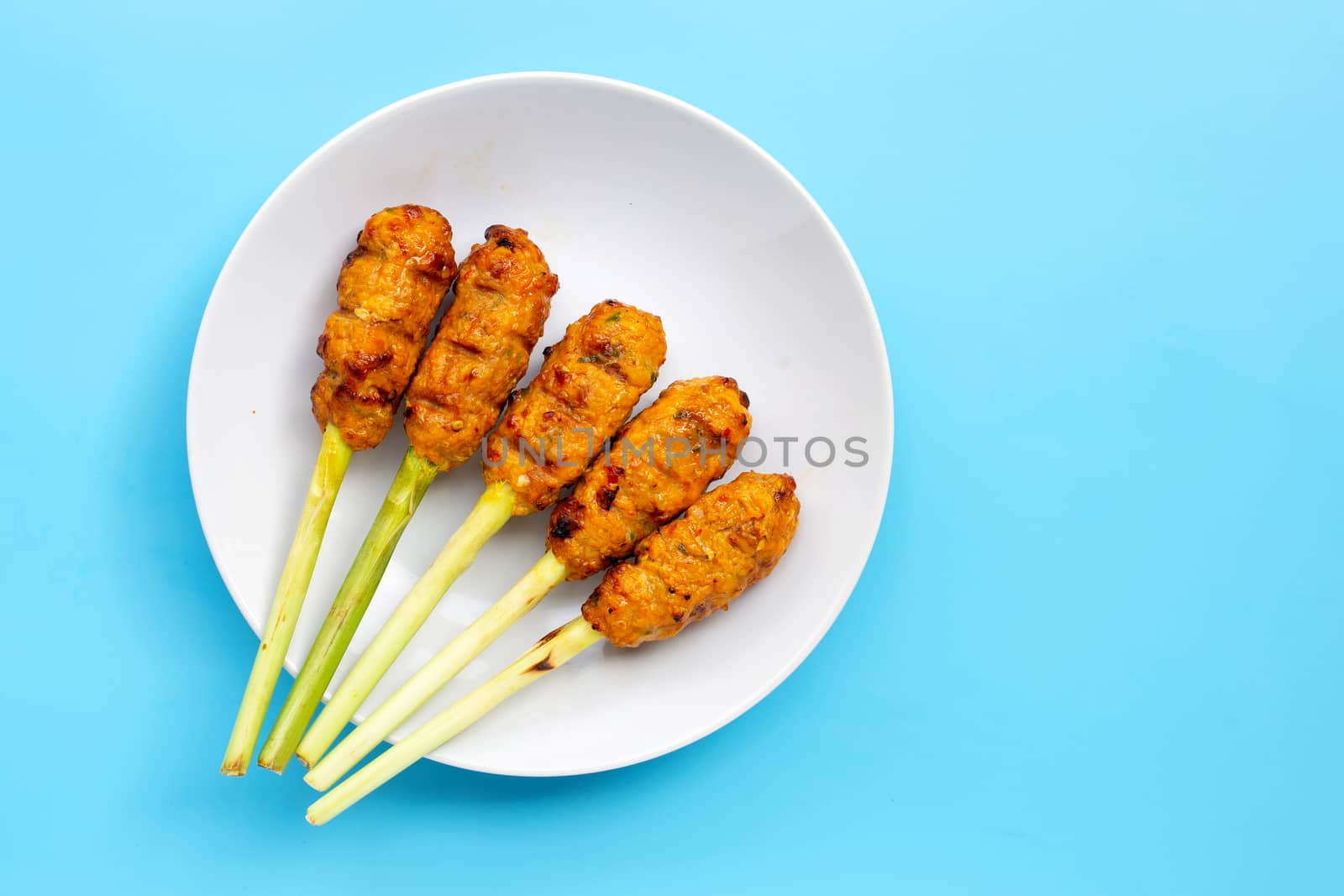 Grilled minced chicken with curry paste and coconut cream on lemongrass skewers. Copy space