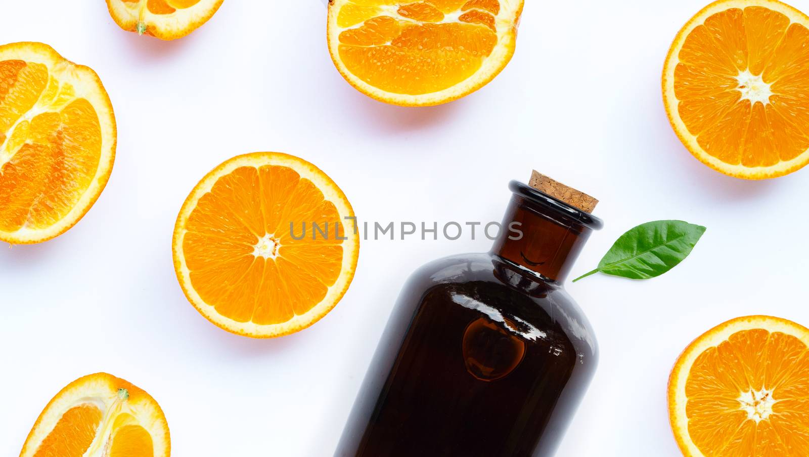 Natural orange essential oil on white background. Top view