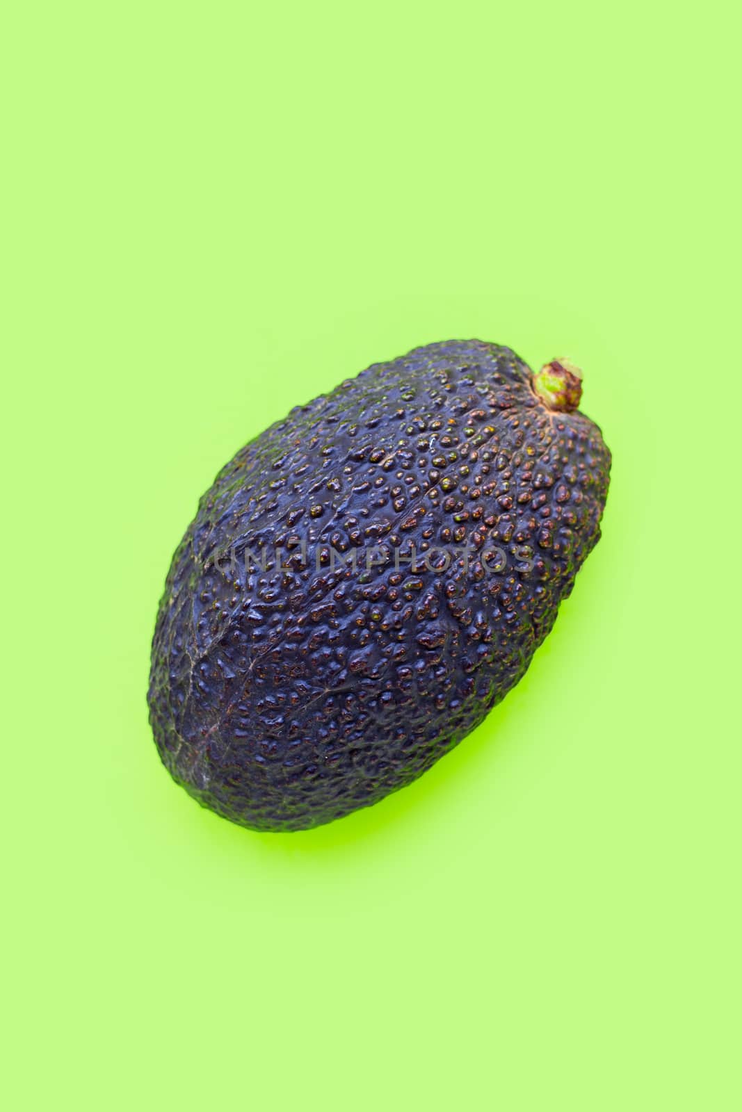 Avocado on green background. Top view