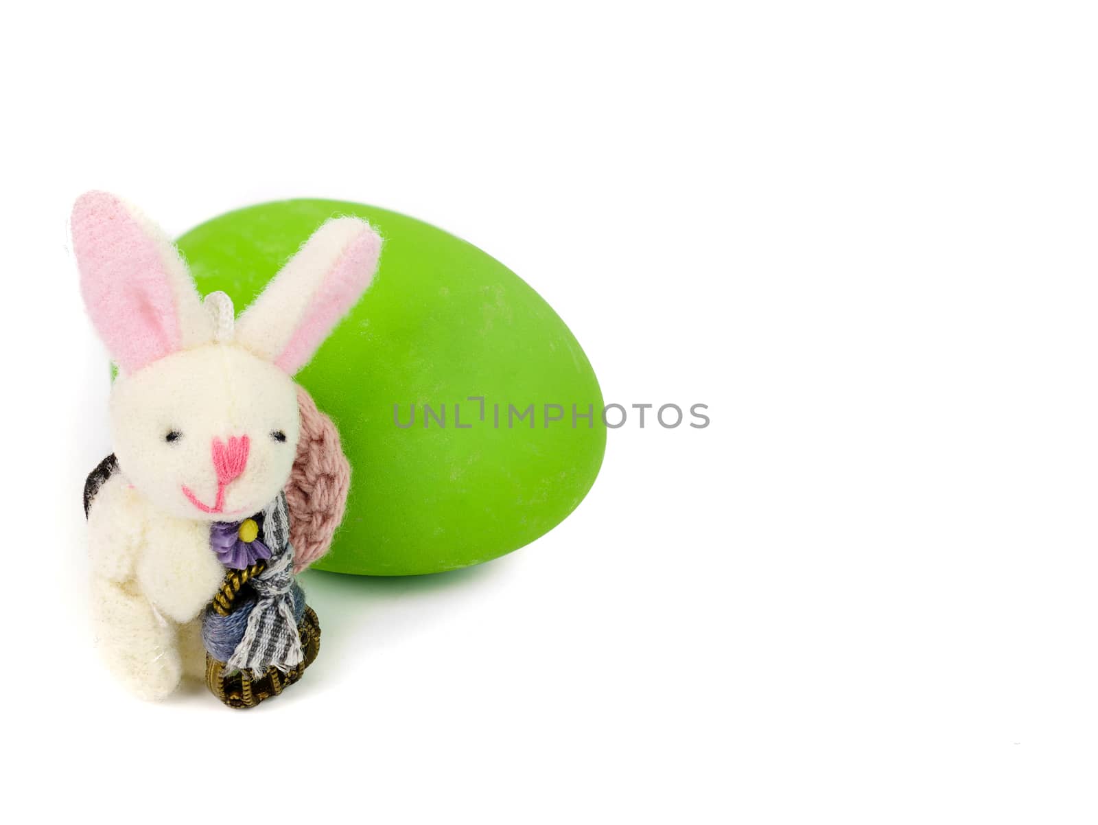 cute little handmade bunny and a green easter egg isolated on white background with copy space
