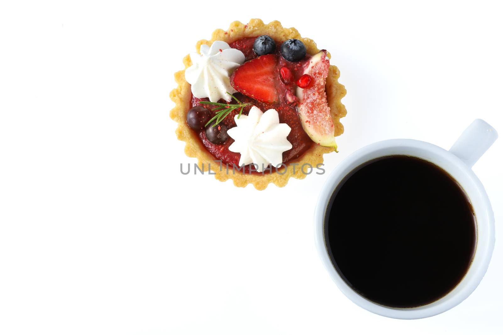 Mixed fruits tart with fig, pomegranate, starfruit, cherry, blueberry, grape, and raspberry jam with a cup of black coffee in white ceramic cup, top view, isolated on white background.