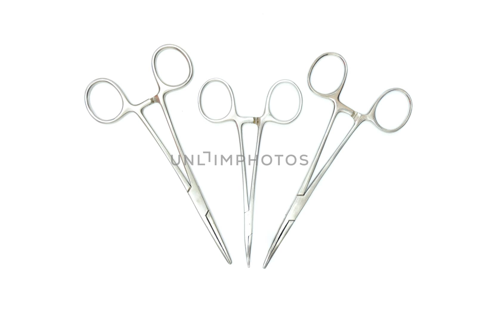 three surgical clamps, isolated on white background, top view