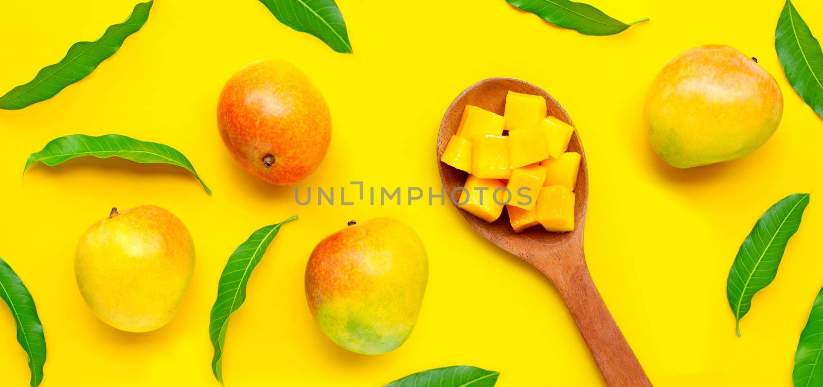 Tropical fruit, Mango on yellow background. by Bowonpat